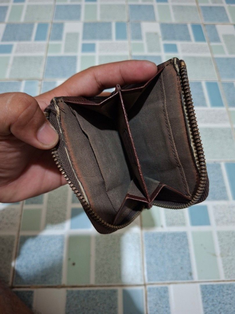 Lee Leather Coin Purse Zip Around Brown (Category: Wallets & Card holders) located in Lapu Lapu. Submitted by margaux099 (Listing ID 1460771277, Image 2). Description: - Brand: Lee - Material: Brown Leather - Closure: Zipper - Size: Small and compact, fits easily in pockets/small bags - Interior: Features a few compartments - Condition: Shows some signs of wear on leather, especially bottom edge. Zipper works smoothly..