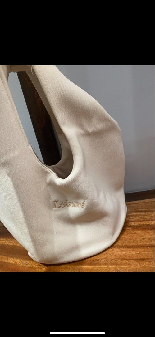 Leisure Supply Cream Tote Bag (Category: Tote Bags) located in Manila. Submitted by kvenriri (Listing ID 1460854405, Image 1). Description: - Cream colored tote bag - 'Leisure' embroidered on the front - Unique cutout handle design - Spacious interior - Soft material - Ideal for everyday use or weekend getaways.