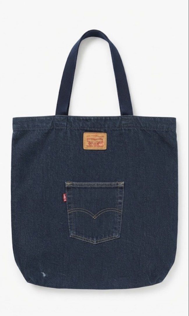 Levi's Denim Tote Bag with Back Pocket (Category: Tote Bags) located in Donsol. Submitted by saksthriftavenuebyluckymaria8 (Listing ID 1460881446, Image 2). Description: - Classic Levi's denim tote bag - Dark wash blue color - Features iconic Levi's back pocket design - Includes leatherette Levi's logo patch - White interior lining with a small pocket - Spacious and ideal for everyday use 17in height .