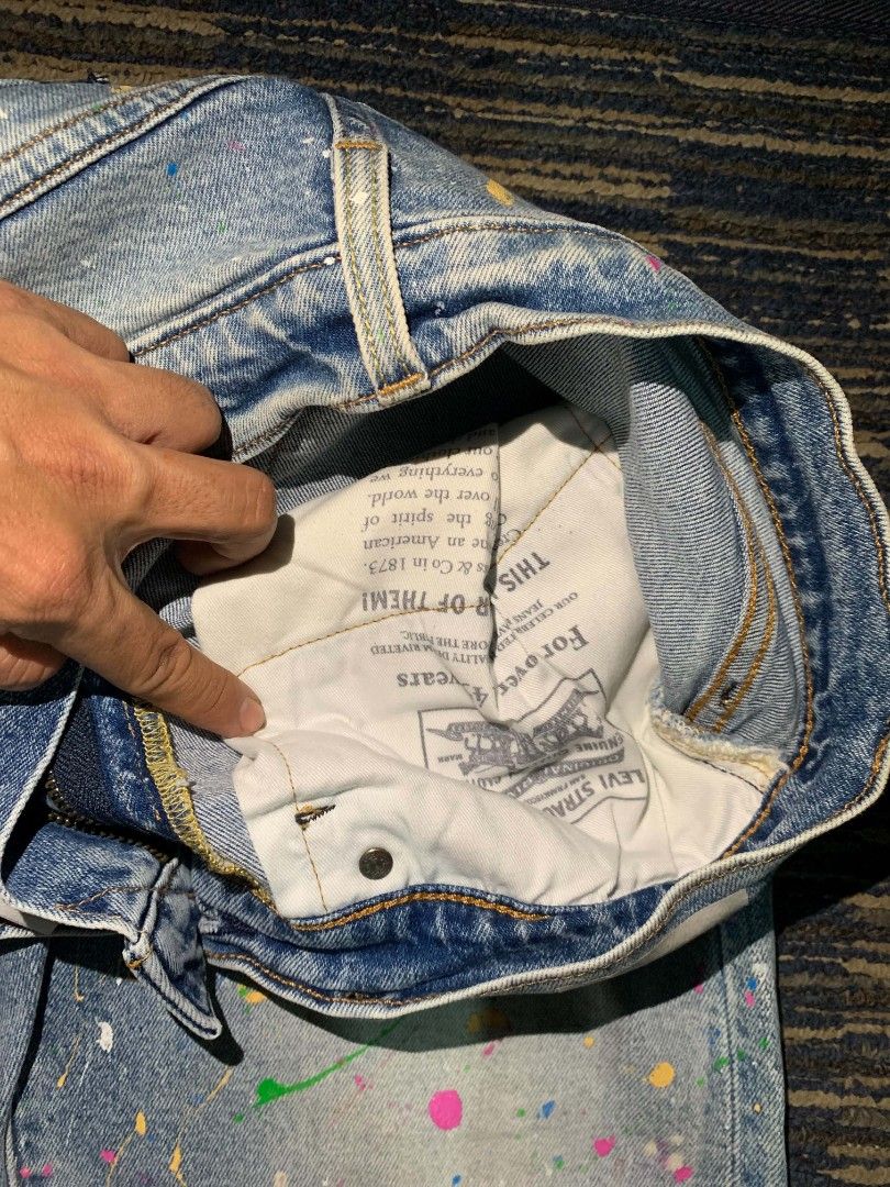 Levi's Premium Jeans - Paint Splatter Design (Category: Jeans) located in Manila. Submitted by itsyourboymat (Listing ID 1460739921, Image 3). Description: - Brand: Levi's Premium selvedge - Size: W32 L34 - Style: Straight Leg - Wash: Light Wash Denim - Design: Unique paint splatter (blue, yellow, pink, green) - Feature: Statement piece for your wardrobe.