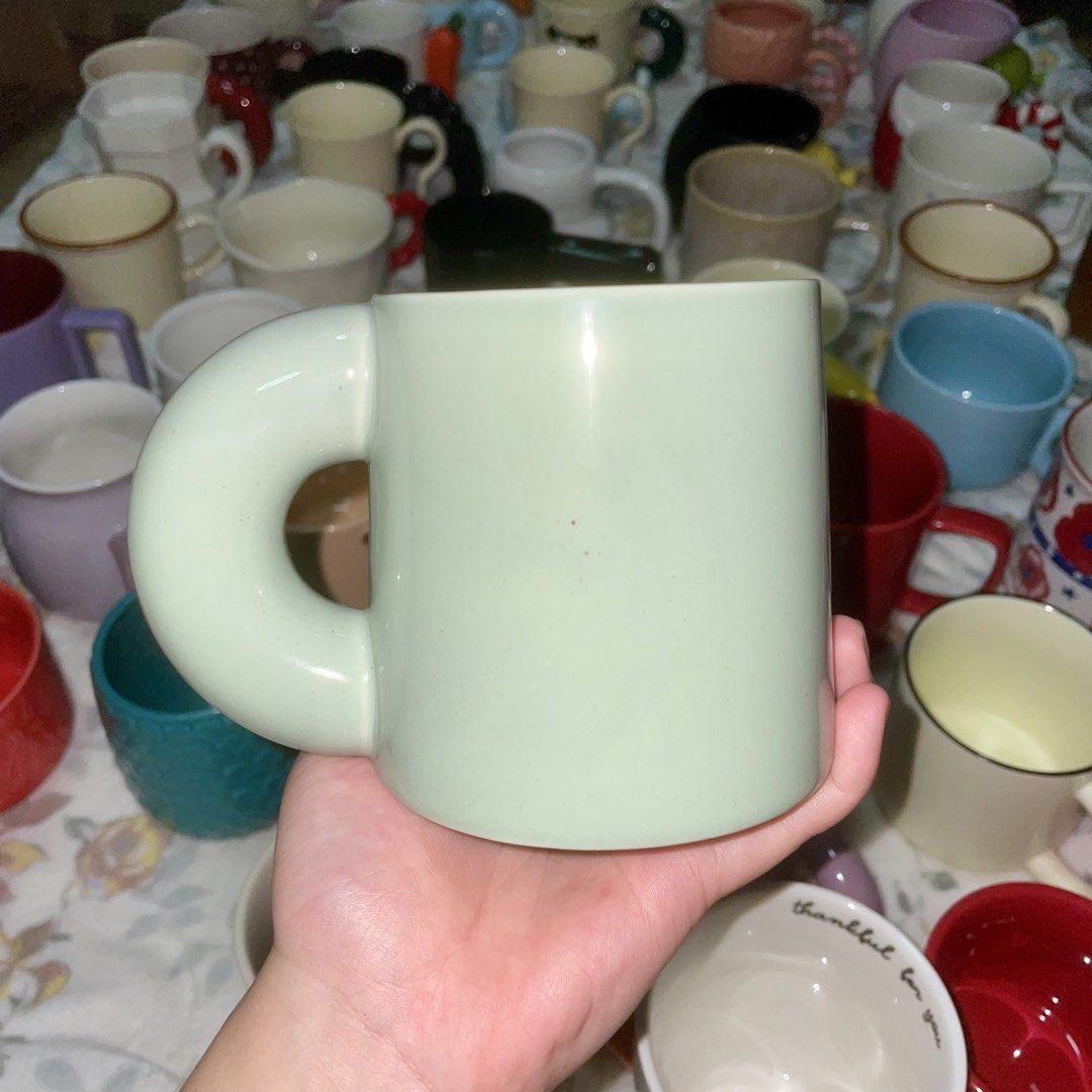 Light Green Ceramic Mug with Unique Handle (Category: Coffee & Tea Tableware) located in Valenzuela. Submitted by baekhyunie_pau (Listing ID 1460810242, Image 1). Description: Unique light green ceramic mug with a comfy rounded handle. Smooth, minimalist design. Great for coffee/tea. Dishwasher & microwave safe..