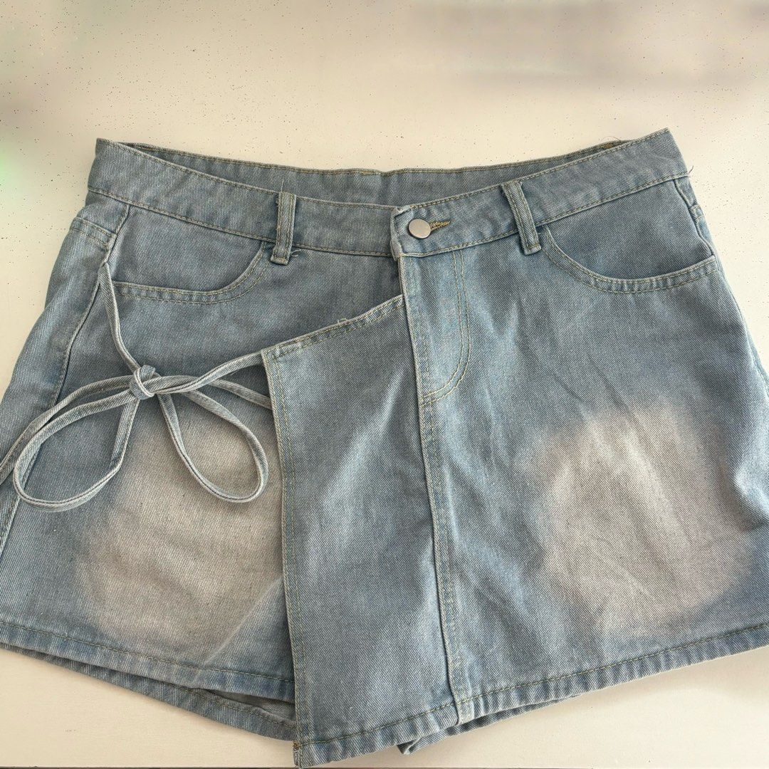 Light Wash Denim Skort with Shorts (Category: Skirts) located in Manila. Submitted by lexiedeclutters (Listing ID 1460761773, Image 1). Description: - waistline: 33-34 - Cute light wash denim skirt shorts - Features a wrap-around tie detail on the side - Classic five-pocket styling - Versatile for pairing with tees or crop tops - Ideal for casual outings or beach days.