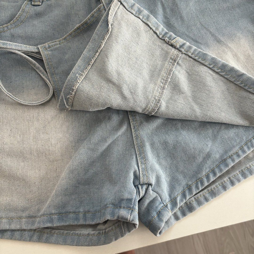 Light Wash Denim Skort with Shorts (Category: Skirts) located in Manila. Submitted by lexiedeclutters (Listing ID 1460761773, Image 2). Description: - waistline: 33-34 - Cute light wash denim skirt shorts - Features a wrap-around tie detail on the side - Classic five-pocket styling - Versatile for pairing with tees or crop tops - Ideal for casual outings or beach days.