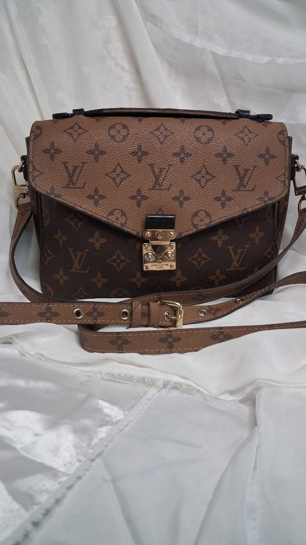 Louis Vuitton Monogram Canvas Shoulder Bag (Category: Luxury Bags & Wallets) located in Taguig. Submitted by divine_kitty (Listing ID 1460917632, Image 1). Description: - Louis Vuitton shoulder bag - Classic monogram canvas - Secure gold-tone clasp closure - Interior leather tags: 'Louis Vuitton Paris Made in France' and smaller tag - Adjustable strap - Ideal for everyday use.