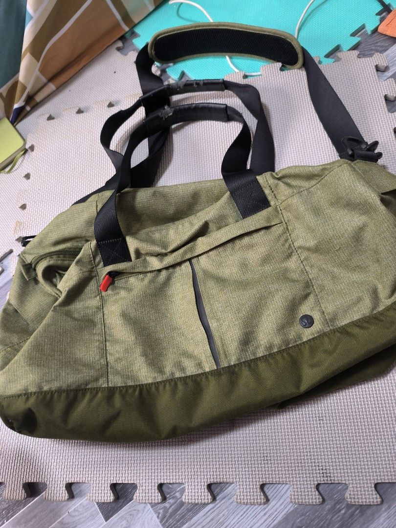 Lululemon Athletica Green Duffel Bag (Category: Shoulder Bags) located in Caloocan City. Submitted by chefems0721 (Listing ID 1460789446, Image 1). Description: - Lululemon Athletica green duffel bag - Made in Vietnam - Material: Body - 46% Nylon, 54% Polyester; Bottom - 100% Nylon - Features: Shoulder strap and handles - Condition: Minor wear on shoulder strap padding - Care: Spot clean only.