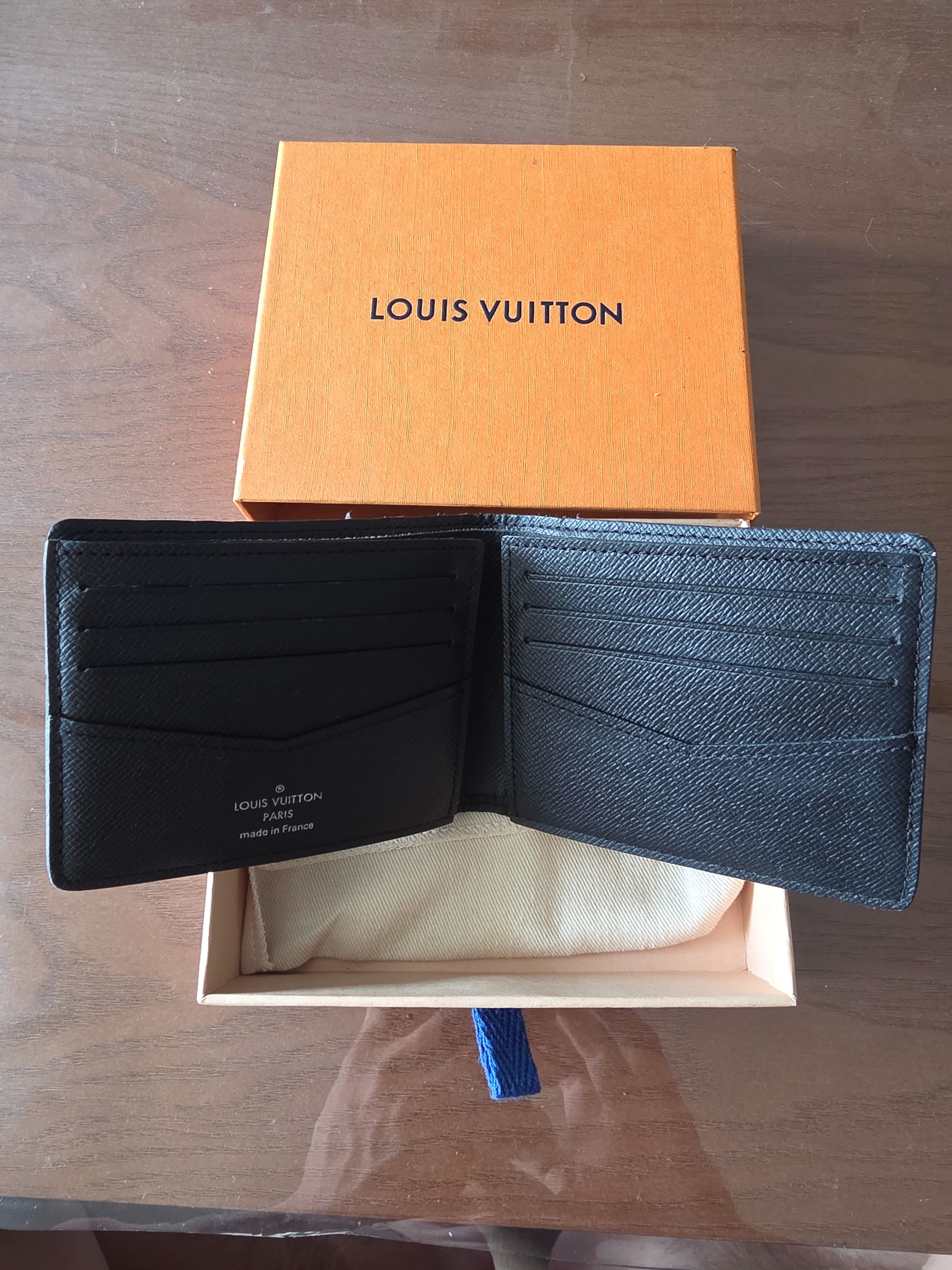 LV Multiple Wallet Monogram Eclipse (Category: Bags & Wallets) located in Singapore. Submitted by sean_neo (Listing ID 1460803731, Image 2). Description: - Brand: Louis Vuitton - Model: Multiple Wallet - Design: Monogram Eclipse canvas - Color: Black and grey - Features: Compact bifold design, multiple card slots - Condition: Well used with edge fraying, not for fussy buyer - Includes: Original Louis Vuitton box.