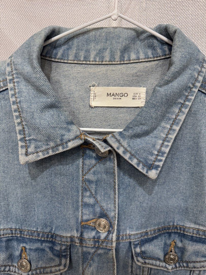 Mango Light Wash Denim Jacket (Category: Coats, Jackets and Outerwear) located in Manila. Submitted by altabl123 (Listing ID 1460855531, Image 2). Description: - Classic light wash denim jacket from Mango - Button-up front closure - Two functional chest pockets - Standard shirt collar - Versatile for layering over tees or dresses - Easy to style for any outfit.