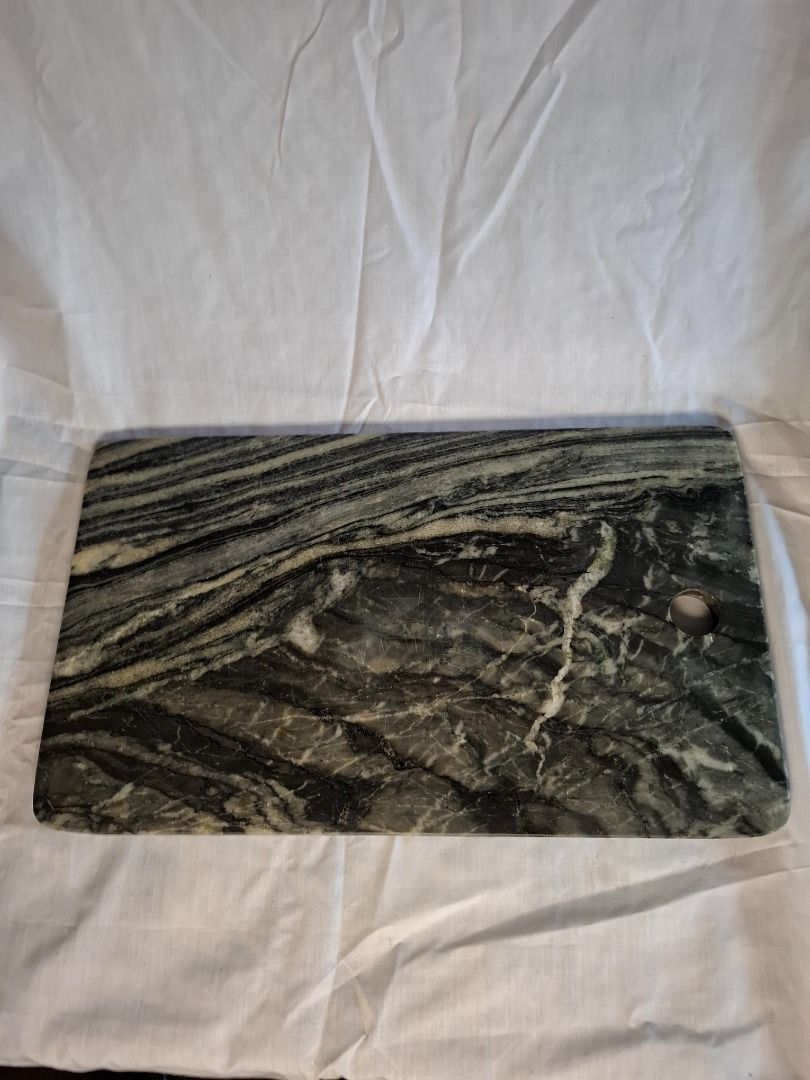 Marble Cutting Board with Hole (Category: Craft Supplies & Tools) located in Mandaluyong City. Submitted by edward123_andren (Listing ID 1460752809, Image 1). Description: - Unique marble cutting board - Striking dark green and white veining - Perfect for both serving and food preparation - Convenient hanging hole - Approximate dimensions: 12 inches x 8 inches - Heavy and durable construction.