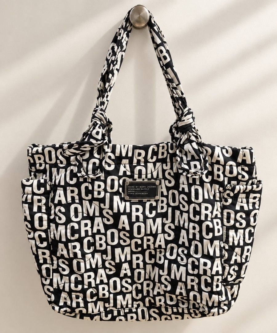 Marc Jacobs Nylon Tote Bag (Category: Tote Bags) located in Quezon City. Submitted by buybyestuffmnl (Listing ID 1460781685, Image 1). Description: White pattern is a little yellowish Good condition. Please note that the bag has a slight storage smell from long-term storage. It may improve after airing out.
