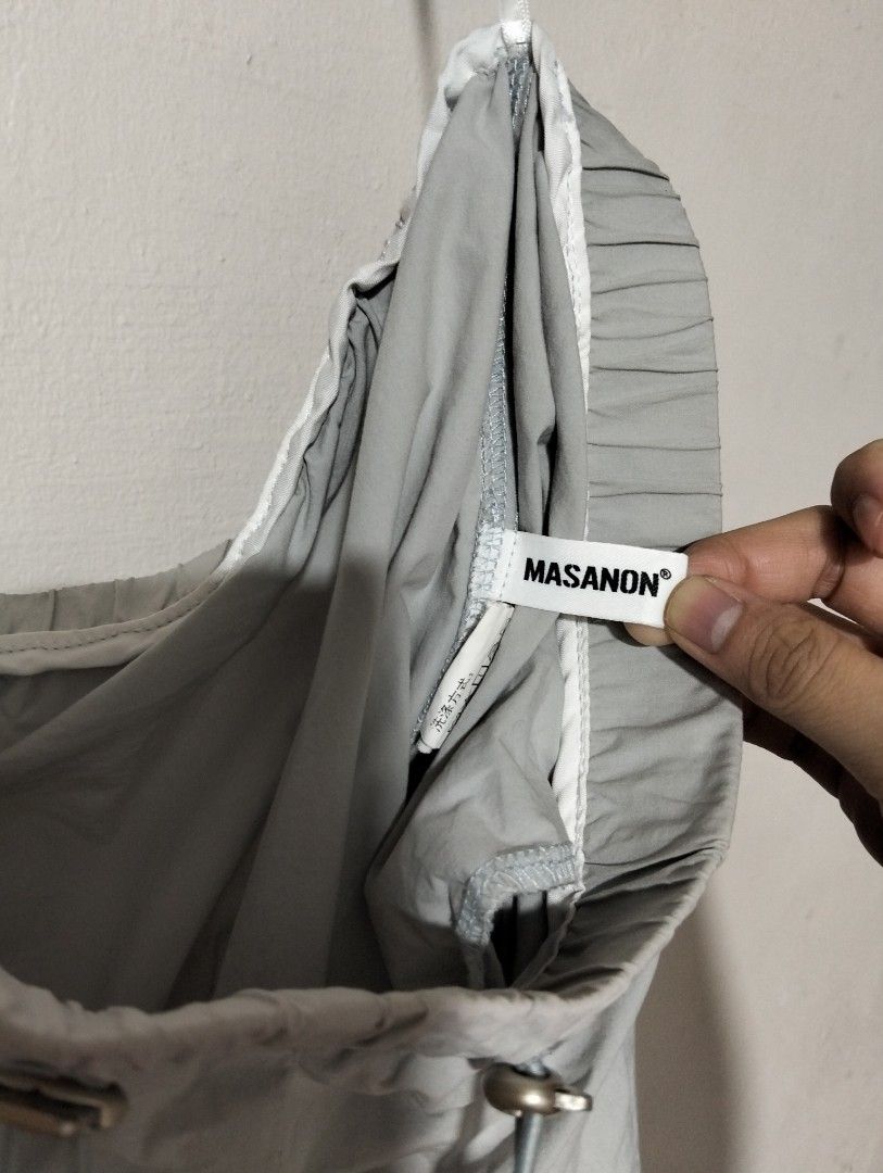 MASANON Grey Drawstring Elastic Waist Shorts, Windbreaker (Category: Shorts) located in Manila. Submitted by oddhorse_8ada97 (Listing ID 1460726428, Image 3). Description: - Brand: MASANON - Color: Grey - Features: Elastic waistband with drawstring, two side pockets - Fit: Relaxed - Fabric: Lightweight and crinkly - Style: Casual wear, easy to wear and adjust good for hiking.