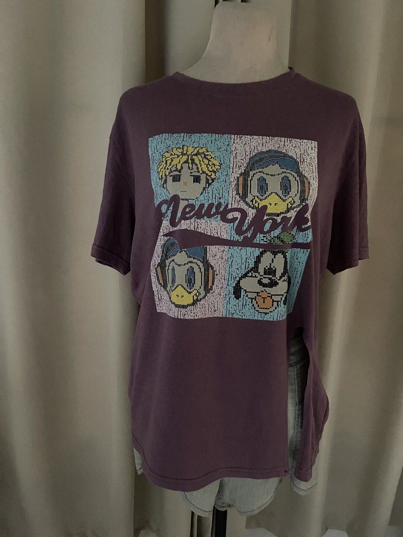 mauve cartoon tee (Category: Shirts) located in Cainta. Submitted by zlove111 (Listing ID 1460731568, Image 1). Description: - Eye-catching purple t-shirt - Features a cool graphic print with cartoon characters - 'New York' text detail - Made from soft, comfortable fabric - Ideal for casual wear - Easily pairs with jeans or shorts - Unique and distinctive design up to xl not crack print .