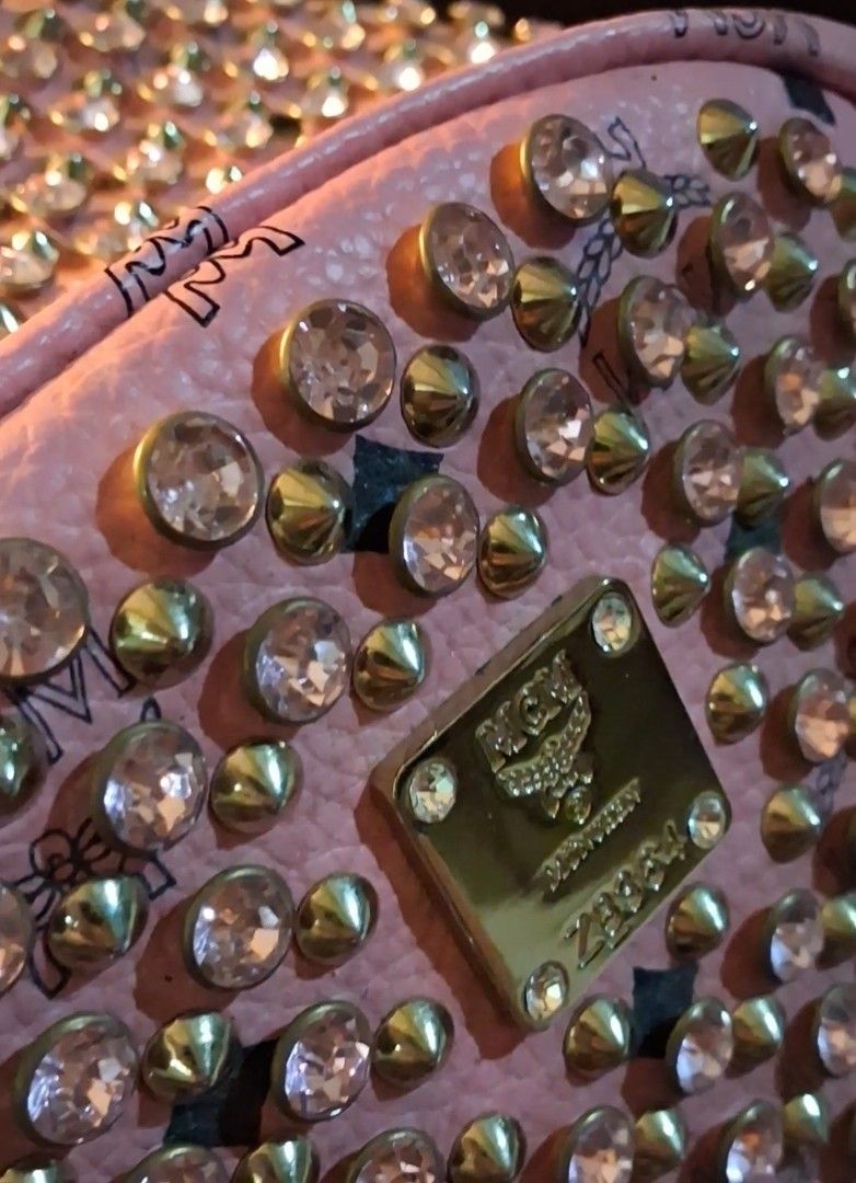 MCM Pink Studded Backpack with Crystals (Category: Backpacks) located in Taguig. Submitted by divine_kitty (Listing ID 1460917381, Image 3). Description: -Authemtic MCM STARCK MCM BACKPACK -SPECIAL EDITION Made in Korea - Eye-catching pink MCM backpack - Adorned with shimmering gold studs and clear crystals - Features the classic MCM logo pattern throughout - Secure zipper closure with a convenient front pocket - Adjustable straps for a comfortab