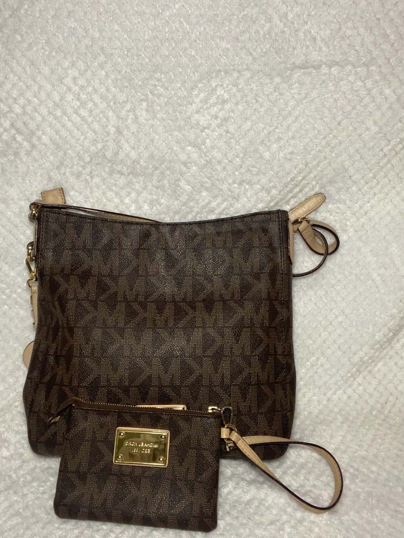 Michael Kors Monogram Handbag with Pouch (Category: Luxury Bags & Wallets) located in Baguio. Submitted by leah_rodrigo (Listing ID 1460760301, Image 1). Description: Authentic Michael Kors monogram handbag in brown. Includes a matching pouch. Features gold hardware and the iconic MK logo charm. Perfect for daily use or travel. Both bag and pouch showcase the signature MK pattern..