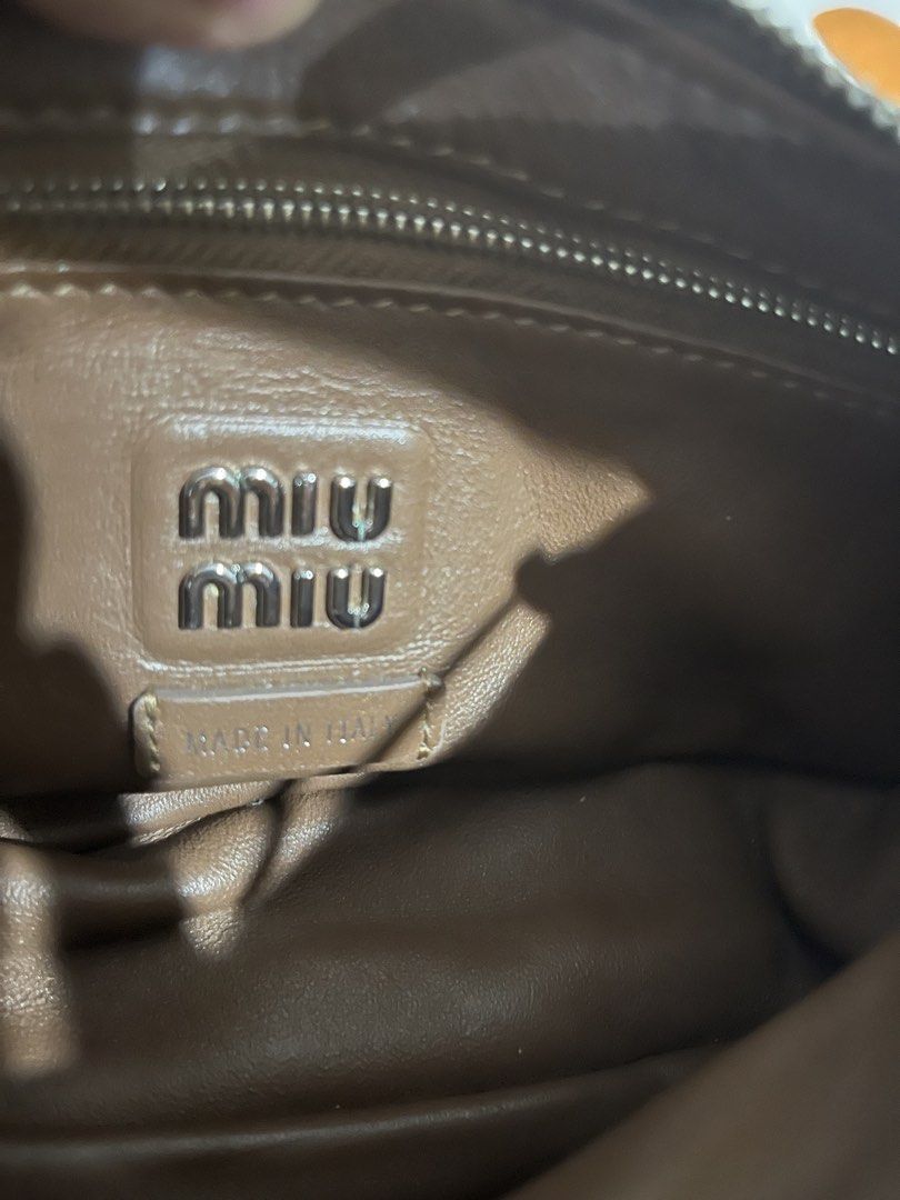 Miu Miu Brown Leather Pocket Bag (Category: Luxury Bags & Wallets) located in Las Pinas. Submitted by erenrosc (Listing ID 1460877074, Image 3). Description: - Miu Miu pocket bag in brown leather. - Multiple front pockets for convenient storage. - Secure top zipper closure. - Interior features Miu Miu logo and 'Made in Italy' tag. - Comfortable single shoulder strap. - Ideal for everyday wear. - With white and black tag - exterior zipper pullers 