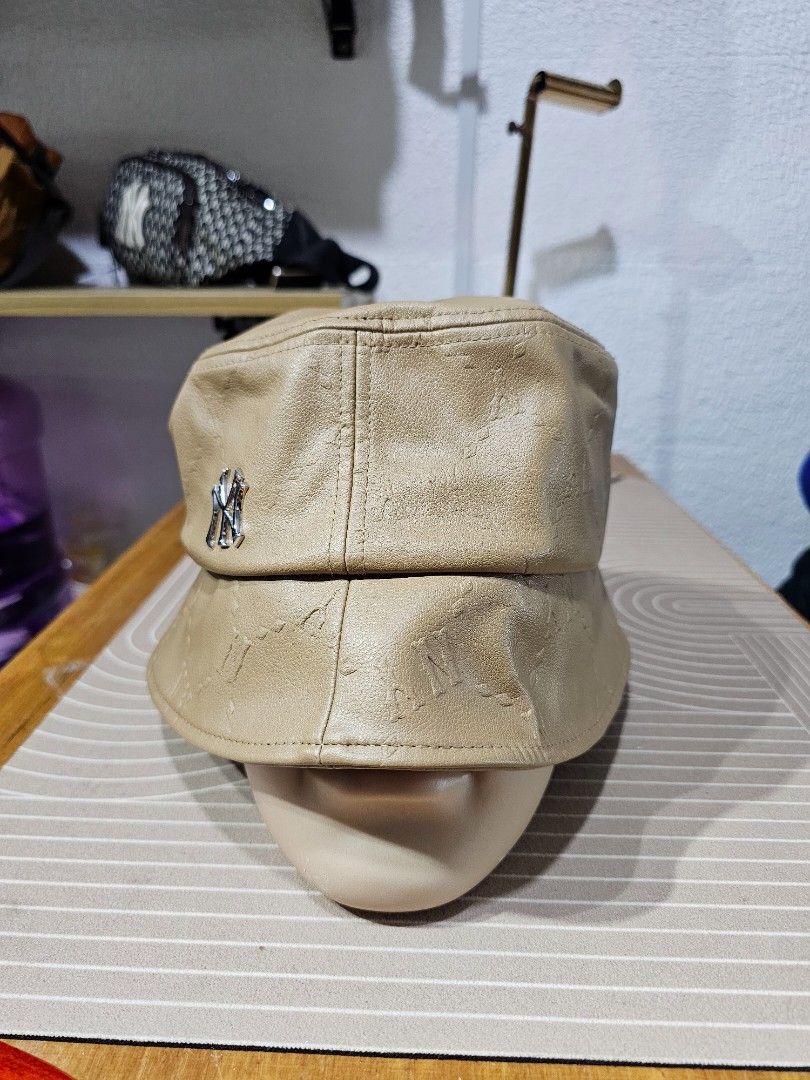 MLB New York Yankees monogram bucket hat (Category: Caps & Hats) located in Baguio. Submitted by kayeonlineshop (Listing ID 1460741506, Image 2). Description: -MLB New York Yankees monogram bucket hat in a tan faux leather finish with a metallic NY logo pin on the front. -unisex.