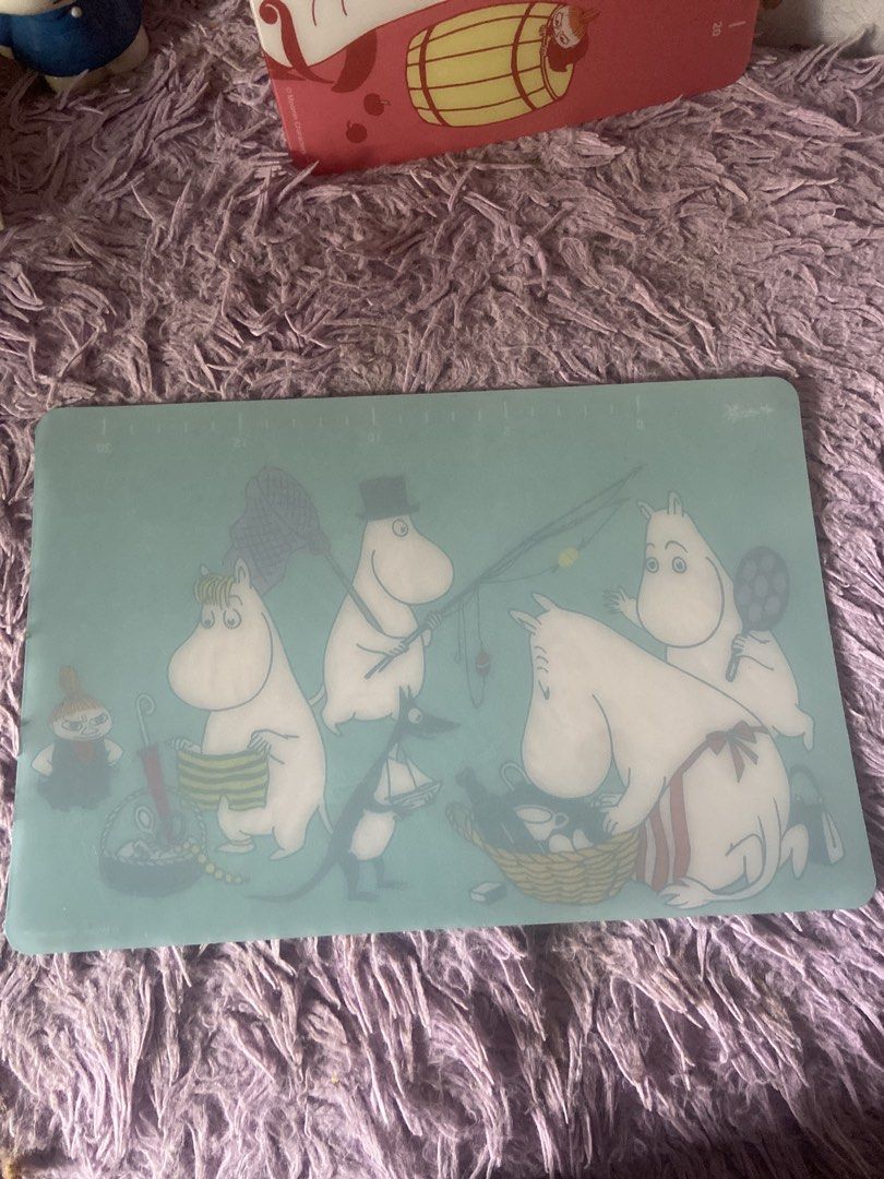 Moomin Cutting Board (Category: Craft Supplies & Tools) located in Davao. Submitted by mengsmixitems (Listing ID 1460781965, Image 2). Description: - Adorable Moomin cutting board - Features beloved Moomin characters - Charming teal background - Convenient measurement markings along the top edge - Ideal for food preparation or as a decorative kitchen accent - Approximate dimensions: 30cm x 20cm.