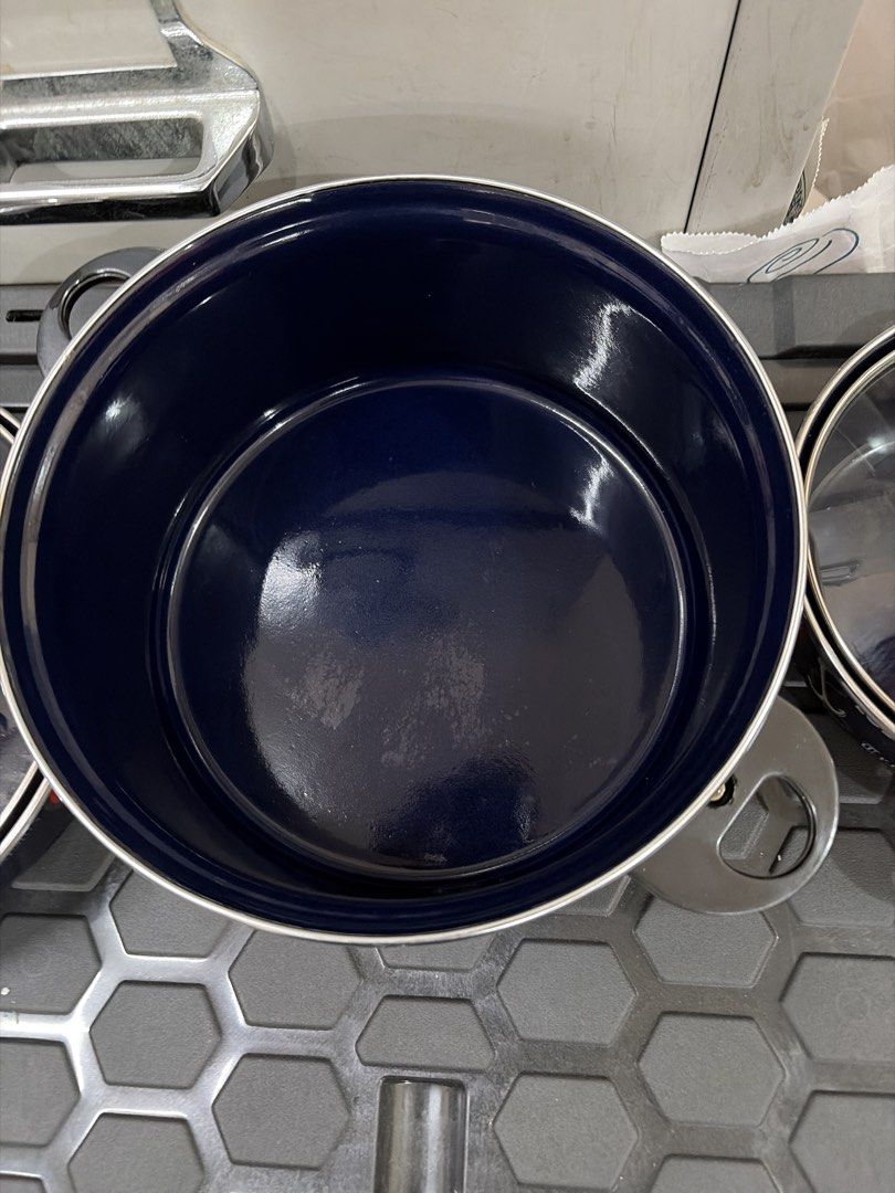 Navy Blue Enamel Cookware Pots with Lids (Category: Cookware & Accessories) located in Quezon City. Submitted by cynlchan (Listing ID 1460773493, Image 2). Description: - 5 pcs navy blue enamel pots 24 cm/18 cm - Each with a glass lid and metal rim/handle - Nautical-themed graphics and text on pots - Largest pot features 'Cod fish LOBSTER Trout' with fish/anchor graphic - Ideal for cooking or as decorative kitchenware.
