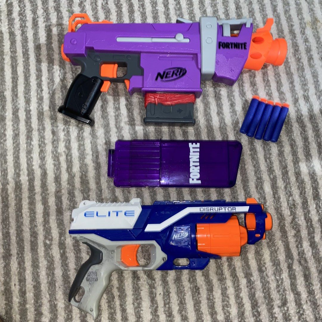 Nerf Fortnite DG and Elite Disruptor Blasters (Category: Action & Battle Toys) located in Pasig City. Submitted by eternalthreads.emporium (Listing ID 1460863230, Image 2). Description: - Two Nerf blasters included: Fortnite DG (purple) and Elite Disruptor (blue/white). - Fortnite DG comes with its magazine and some darts. - Both blasters are in working condition and ready for play. - Perfect for backyard battles, games, or adding to your Nerf co