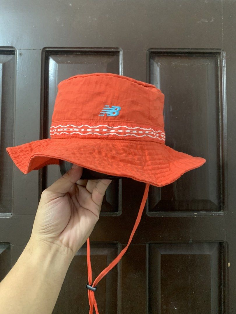 New Balance Bush hat (Category: Caps & Hats) located in Manila. Submitted by ekeithdgzm41324 (Listing ID 1460797540, Image 1). Description: New Balance orange bucket hat with embroidered logo and patterned band. Adjustable drawstring. Perfect for sunny days..