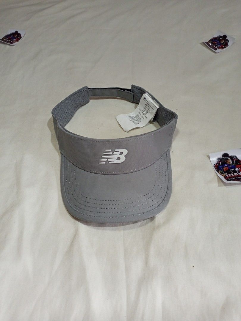 New Balance Visor Cap Hat (Category: Caps & Hats) located in General Santos City (Dadiangas). Submitted by nonoks1234 (Listing ID 1460920369, Image 1). Description: - Grey and black New Balance visors - Ideal for sports or sunny weather - Adjustable strap at the back for a comfortable fit - Features the New Balance logo on the front - Available for purchase as a pair or separately.