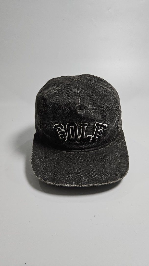 New Era Golf Snapback Cap (Category: Caps & Hats) located in Alfonso. Submitted by jbcamet (Listing ID 1460829929, Image 1). Description: - Black denim-look snapback cap - Features 'GOLF' embroidered in white on the front - New Era logo detail on the side - Adjustable snap closure for a custom fit - Ideal for casual outings or sports activities.