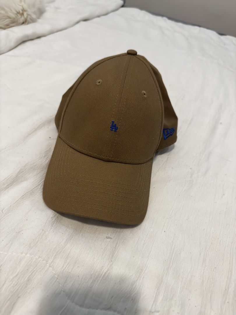 New Era LA Dodgers Baseball Cap (Category: Caps & Hats) located in Marikina City. Submitted by daintyaesthetics (Listing ID 1460811988, Image 1). Description: - Brown New Era cap - Features embroidered LA Dodgers logo in blue on the front - New Era logo on the side - Adjustable strap at the back - Ideal for everyday wear.