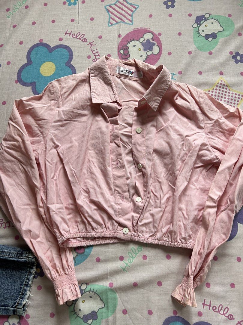 NEXT Pink Cropped Button-Up Shirt Size S (Category: Shirts) located in Antipolo. Submitted by sophueya (Listing ID 1460746653, Image 1). Description: - Pink cropped shirt from NEXT - Button-up front with a collar - Elasticated hem and cuffs - Long sleeves - Easy to style with jeans or shorts for a casual look.