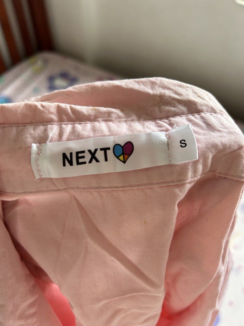 NEXT Pink Cropped Button-Up Shirt Size S (Category: Shirts) located in Antipolo. Submitted by sophueya (Listing ID 1460746653, Image 3). Description: - Pink cropped shirt from NEXT - Button-up front with a collar - Elasticated hem and cuffs - Long sleeves - Easy to style with jeans or shorts for a casual look.