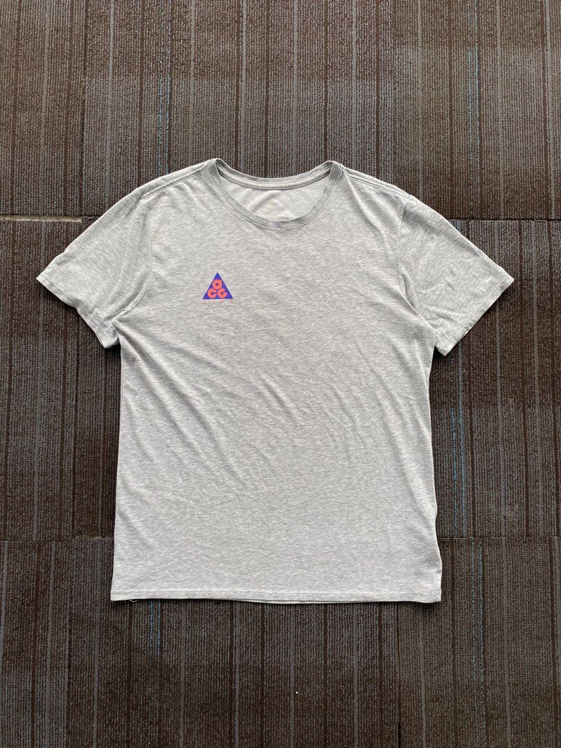 Nike ACG “Go Climb A Volcano” Tee (s19) (Category: Activewear) located in Taguig. Submitted by offther4ck (Listing ID 1460814501, Image 1). Description: - Issue: Faded Neck tag and Wide neckline - Size Large on tag - Dri-Fit - Width: 20 inches - Length: 27 inches.