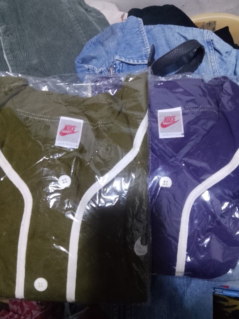 Nike Baseball Jersey - Green and Purple (Category: Activewear) located in Quezon City. Submitted by theoneshop1 (Listing ID 1460737251, Image 1). Description: - Two Nike baseball jerseys for sale - Available colors: Olive Green and Deep Purple - Features classic white piping - Button-up front design - Nike logo tag clearly visible.