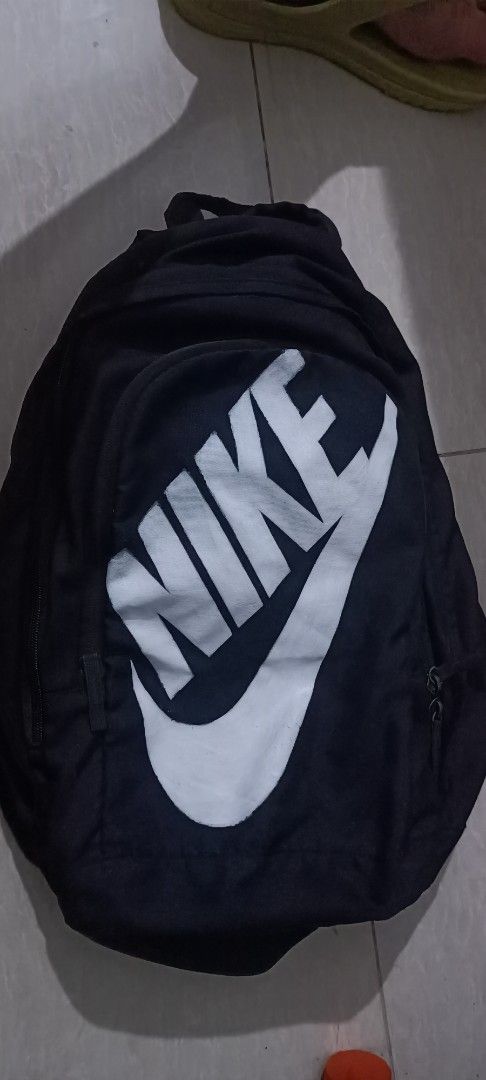 Nike Black Backpack with Large White Swoosh Logo (Category: Backpacks) located in Manila. Submitted by jacovstore1989 (Listing ID 1460742163, Image 1). Description: - Classic black Nike backpack - Iconic large white swoosh logo on front - Main compartment with zipper used - Front pocket with zipper - Adjustable straps for comfort - Ideal for everyday use or sports activities.