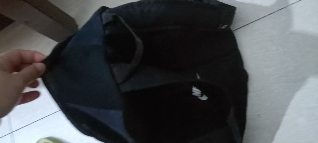 Nike Black Backpack with Large White Swoosh Logo (Category: Backpacks) located in Manila. Submitted by jacovstore1989 (Listing ID 1460742163, Image 2). Description: - Classic black Nike backpack - Iconic large white swoosh logo on front - Main compartment with zipper used - Front pocket with zipper - Adjustable straps for comfort - Ideal for everyday use or sports activities.