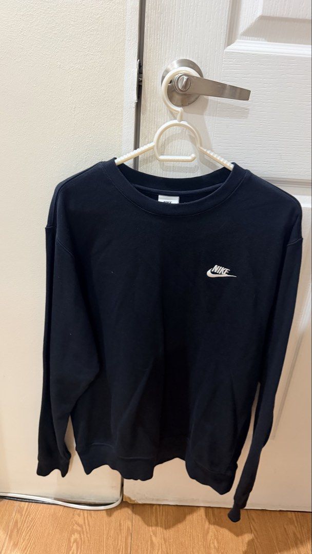 Nike Crewneck Sweatshirt Black (Category: Coats, Jackets and Outerwear) located in Manila. Submitted by miss.shoppaholic (Listing ID 1460742211, Image 2). Description: - Classic black Nike crewneck sweatshirt - Features iconic embroidered Nike swoosh on chest - Long sleeves and crew neckline - Comfortable and versatile for everyday wear or layering.