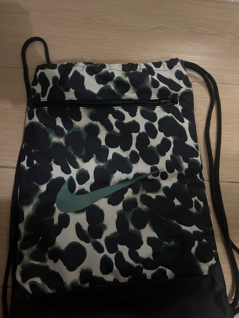 Nike Drawstring Bag - Leopard Print (Category: Backpacks) located in Manila. Submitted by newshark_db9669 (Listing ID 1460863276, Image 1). Description: - Stylish Nike drawstring bag - Eye-catching green and black leopard print - Convenient front zippered pocket for essentials - Iconic Nike swoosh logo - Ideal for gym, sports, or everyday carry.