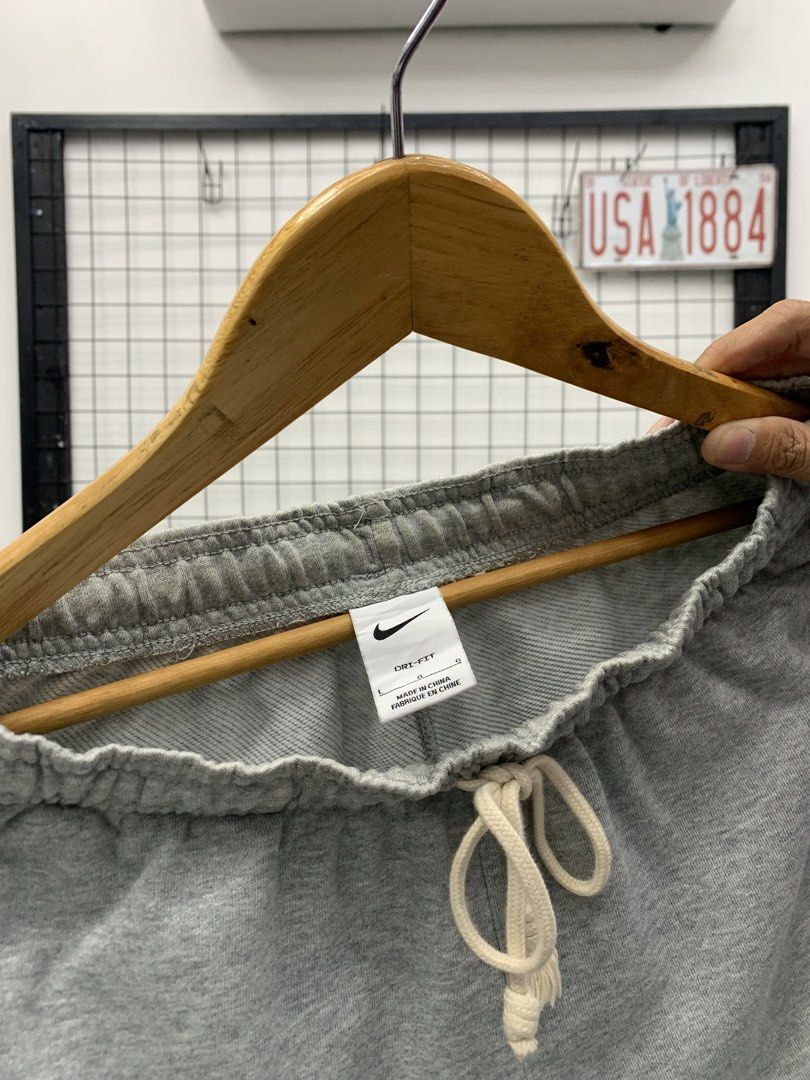 Nike Grey Dri-FIT Sweatpants (Category: Joggers) located in Cavite. Submitted by jeromeaba95864 (Listing ID 1460911076, Image 2). Description: - Grey Nike sweatpants - Dri-FIT material for sweat-wicking - Elastic waistband with adjustable drawstring - Side pockets, one with a secure zipper - Small Nike logo detail on the left leg - Cuffed ankles for a snug fit - Ideal for workouts, sports, or casual lounging.