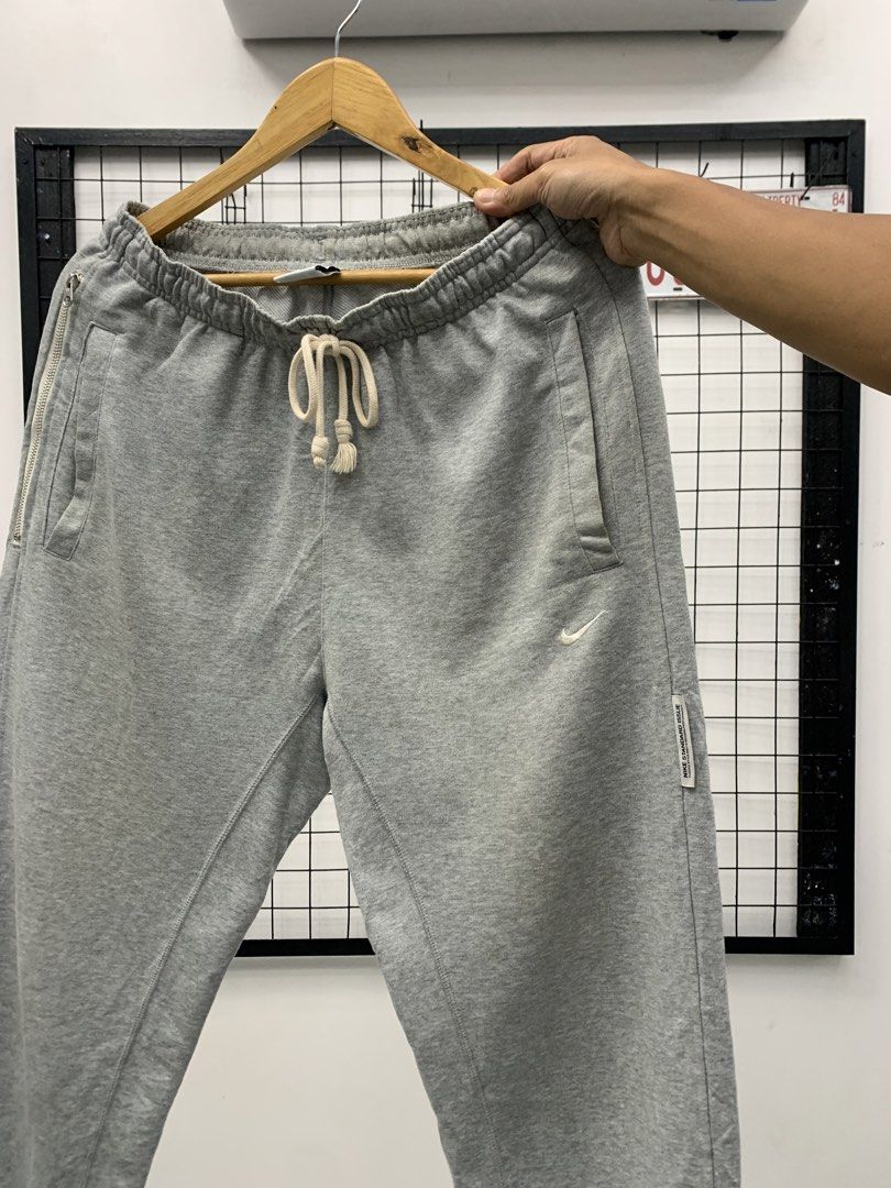Nike Grey Dri-FIT Sweatpants (Category: Joggers) located in Cavite. Submitted by jeromeaba95864 (Listing ID 1460911076, Image 3). Description: - Grey Nike sweatpants - Dri-FIT material for sweat-wicking - Elastic waistband with adjustable drawstring - Side pockets, one with a secure zipper - Small Nike logo detail on the left leg - Cuffed ankles for a snug fit - Ideal for workouts, sports, or casual lounging.