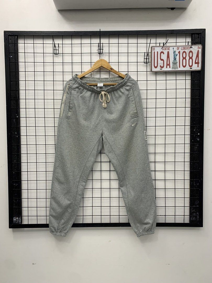 Nike Grey Dri-FIT Sweatpants (Category: Joggers) located in Cavite. Submitted by jeromeaba95864 (Listing ID 1460911076, Image 1). Description: - Grey Nike sweatpants - Dri-FIT material for sweat-wicking - Elastic waistband with adjustable drawstring - Side pockets, one with a secure zipper - Small Nike logo detail on the left leg - Cuffed ankles for a snug fit - Ideal for workouts, sports, or casual lounging.