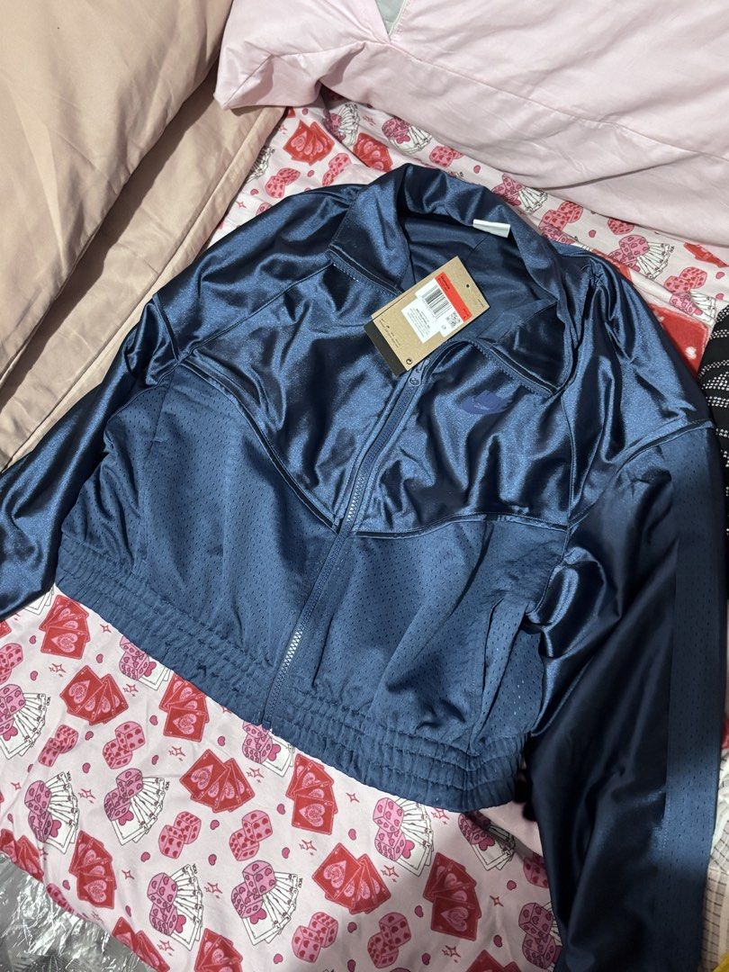 Nike Navy Blue Track Jacket (Category: Coats, Jackets and Outerwear) located in Quezon City. Submitted by socks4sale (Listing ID 1460793951, Image 2). Description: - Navy blue Nike track jacket - Cropped style with a shiny finish - Mesh paneling on chest and sleeves - Elasticated hem and cuffs - Zip-up front Brand new with tag size large. Original nike jacket.
