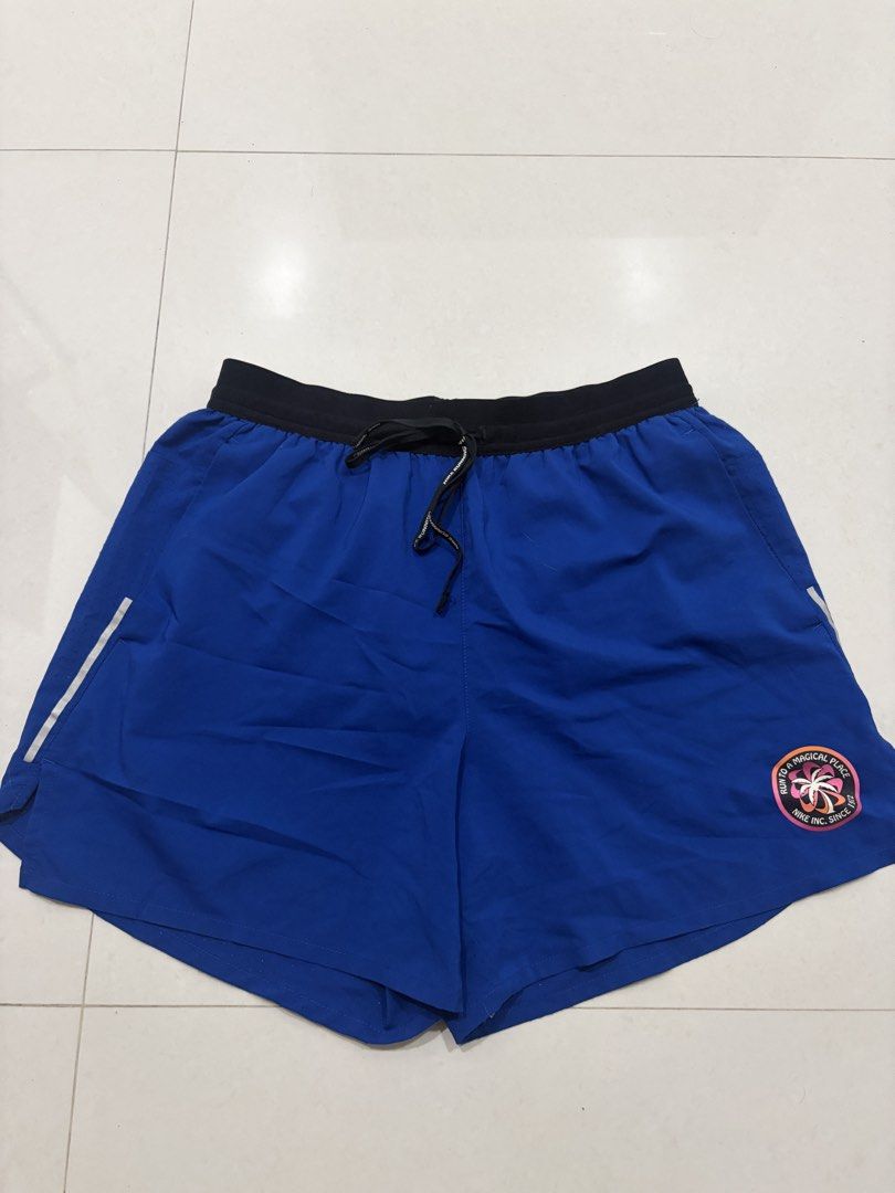 Nike Running Shorts Blue (Category: Activewear) located in Marilao. Submitted by astroman.22 (Listing ID 1460888080, Image 1). Description: - Blue Nike running shorts - Elastic waistband with drawstring - Small logo detail on lower right leg - Reflective strip on left side - Ideal for workouts and casual wear.