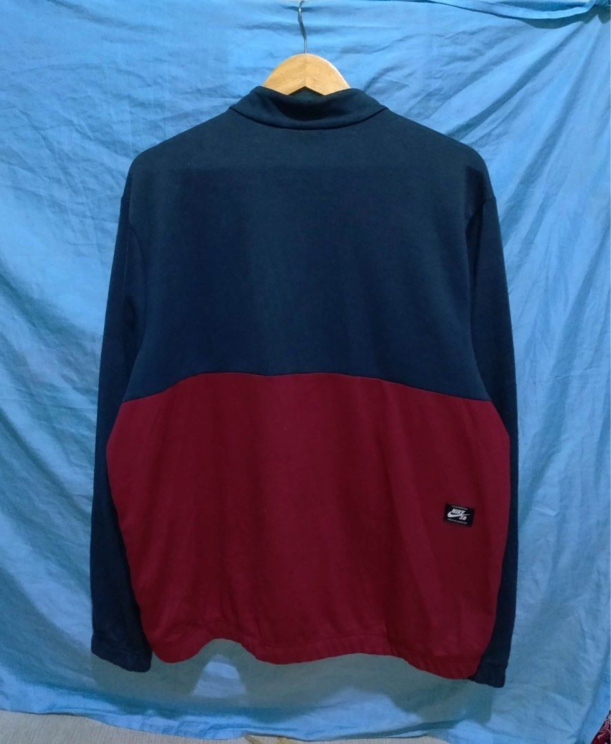 Nike SB Track Jacket Navy Red Zip Up (Category: Coats, Jackets and Outerwear) located in Calamba. Submitted by patrickbarcala268 (Listing ID 1460721108, Image 2). Description: - Nike SB Navy and Red Colorblock Track Jacket - Full zip closure with stand-up collar - Embroidered Nike SB logo on chest - Ribbed cuffs and hem for a snug fit - Ideal for casual outfits or as a layering piece.