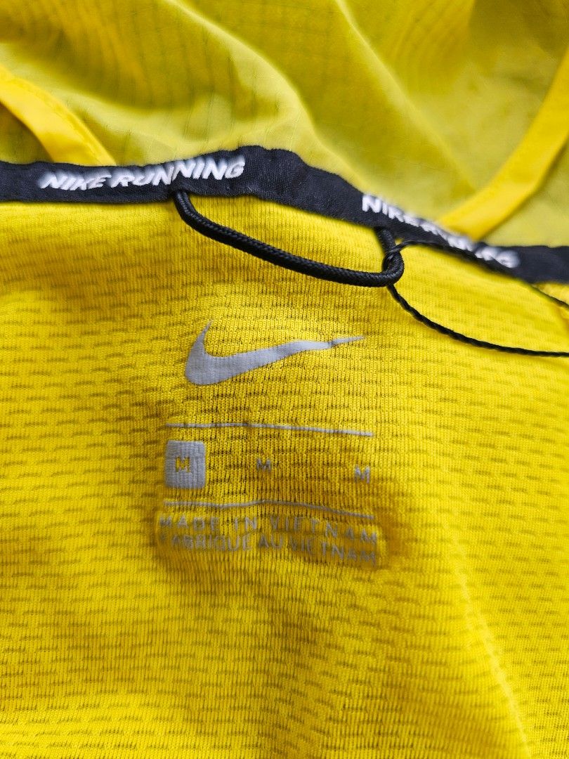 Nike wind runner trail jacket (Category: Coats, Jackets and Outerwear) located in Baguio. Submitted by kayeonlineshop (Listing ID 1460771349, Image 3). Description: -bright yellow Nike Windrunner Trail Jacket featuring a black topographical line pattern across the lower half and sleeves -measurements included in the photos.