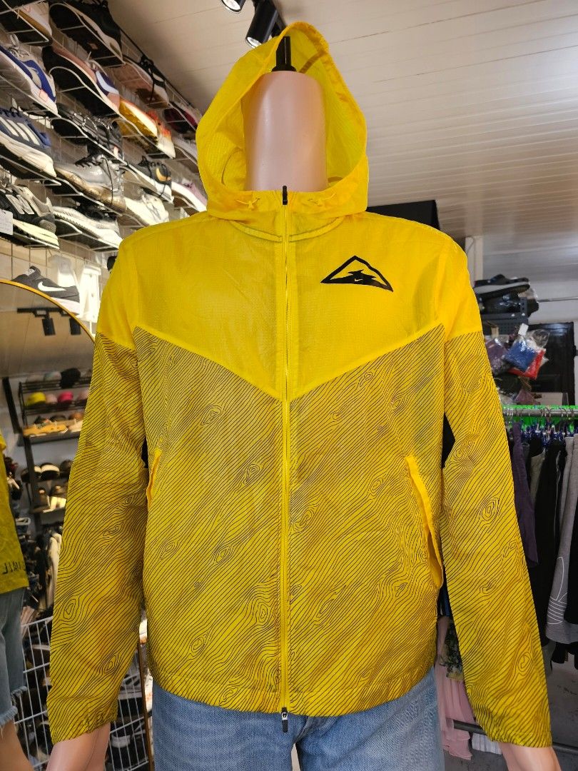 Nike wind runner trail jacket (Category: Coats, Jackets and Outerwear) located in Baguio. Submitted by kayeonlineshop (Listing ID 1460771349, Image 2). Description: -bright yellow Nike Windrunner Trail Jacket featuring a black topographical line pattern across the lower half and sleeves -measurements included in the photos.
