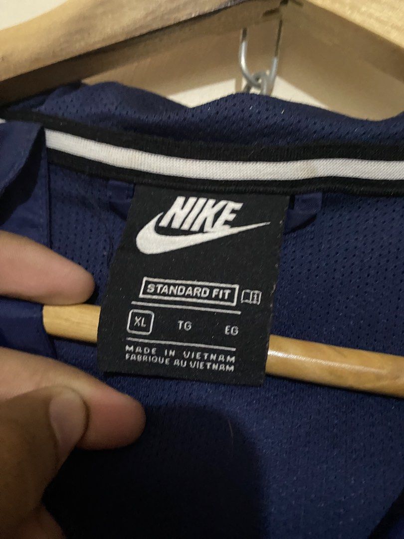Nike Windbreaker Jacket (Category: Coats, Jackets and Outerwear) located in San Jose del Monte. Submitted by dripfromthrift2 (Listing ID 1460717150, Image 3). Description: - Classic Nike windbreaker jacket - Iconic swoosh logo - Color-blocked design: navy, white, and red - Lightweight and perfect for layering - Great for casual wear or sports.