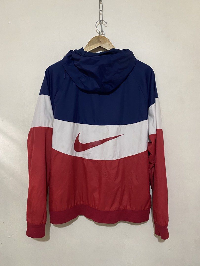 Nike Windbreaker Jacket (Category: Coats, Jackets and Outerwear) located in San Jose del Monte. Submitted by dripfromthrift2 (Listing ID 1460717150, Image 2). Description: - Classic Nike windbreaker jacket - Iconic swoosh logo - Color-blocked design: navy, white, and red - Lightweight and perfect for layering - Great for casual wear or sports.