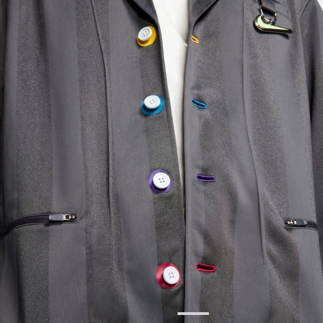 Nike x Pigalle Tracksuit Jacket (Category: Coats, Jackets and Outerwear) located in Las Pinas. Submitted by rcp123 (Listing ID 1460803449, Image 3). Description: - Best Fit medium to Large - 27 x 18 - Color may vary due to lighting - Eye-catching vertical stripes and colorful button details. - Signature Nike Swoosh logo for an authentic look. - Convenient zippered pockets on the sides. - Comfortable ribbed cuffs and hem. - Made from 100% polyeste