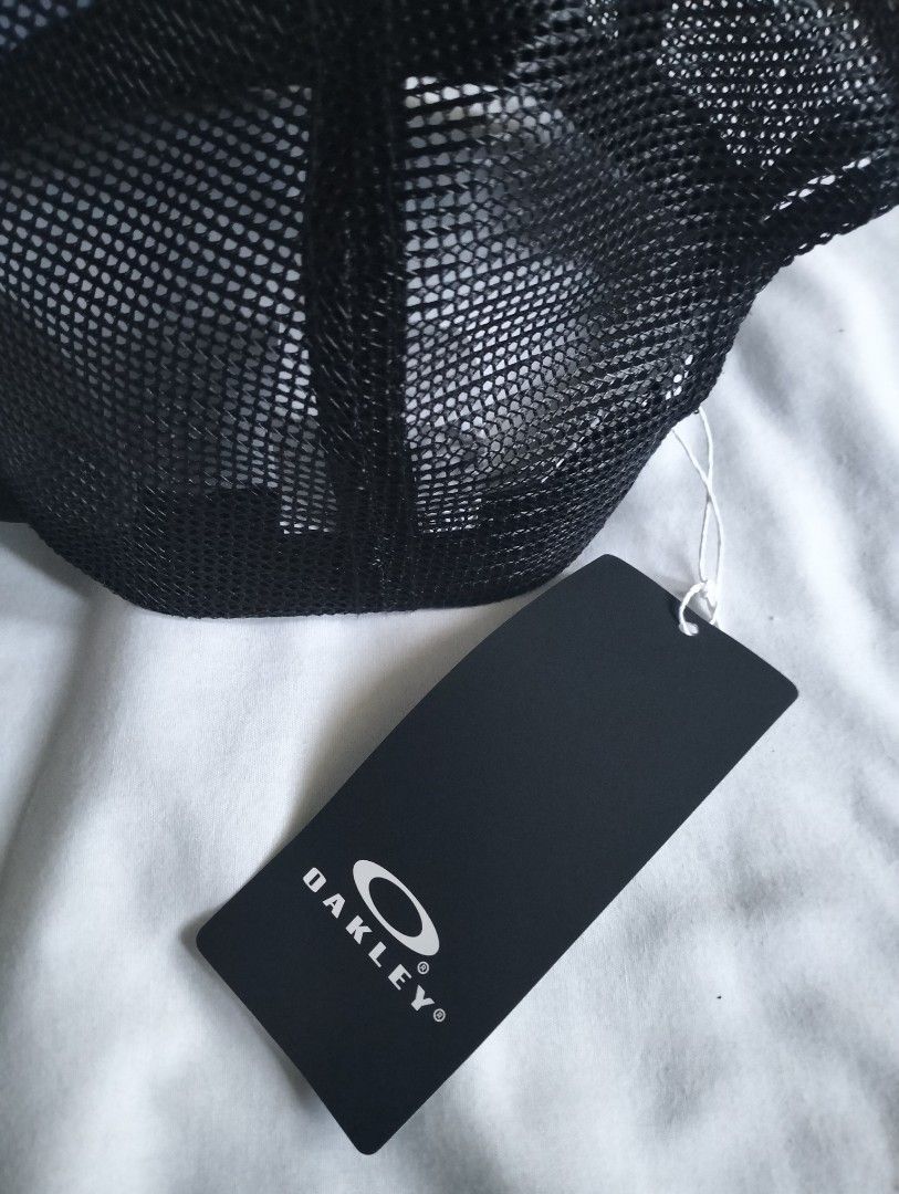 Oakley Black Mesh Trucker Cap (Category: Caps & Hats) located in Cavite. Submitted by cocorancho (Listing ID 1460715983, Image 3). Description: - Authentic Oakley trucker cap - Breathable mesh back - Iconic Oakley logo patch on front - Adjustable strap for a custom fit - Brand new with original tag attached - Designed in USA, made in Bangladesh.