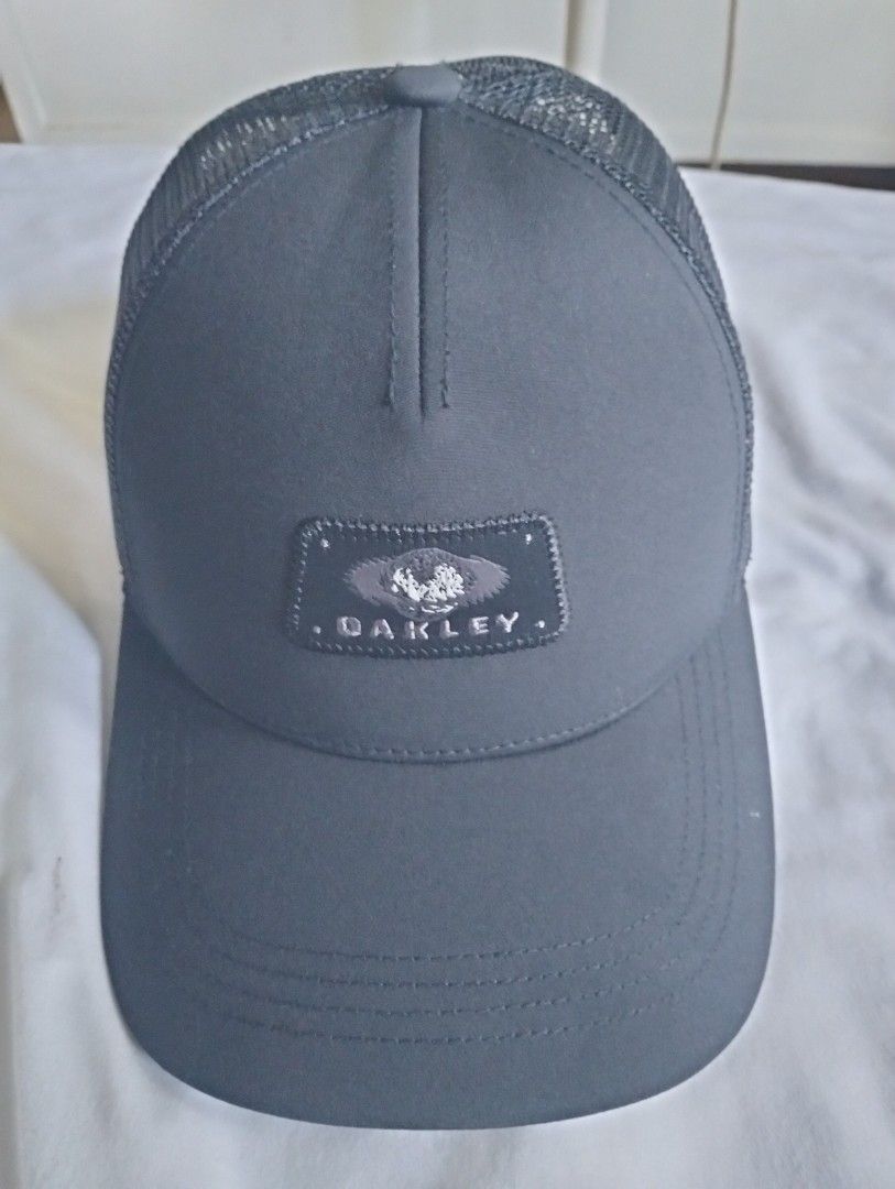 Oakley Black Mesh Trucker Cap (Category: Caps & Hats) located in Cavite. Submitted by cocorancho (Listing ID 1460715983, Image 1). Description: - Authentic Oakley trucker cap - Breathable mesh back - Iconic Oakley logo patch on front - Adjustable strap for a custom fit - Brand new with original tag attached - Designed in USA, made in Bangladesh.