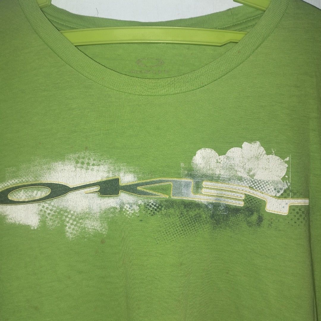 Oakley Green T-shirt (Category: Tshirts & Polo Shirts ) located in Manila. Submitted by ghst.thrift (Listing ID 1460738997, Image 2). Description: vintage/y2k Oakley ISSUE- HAIR LINE,STAIN,PIN HOLE.