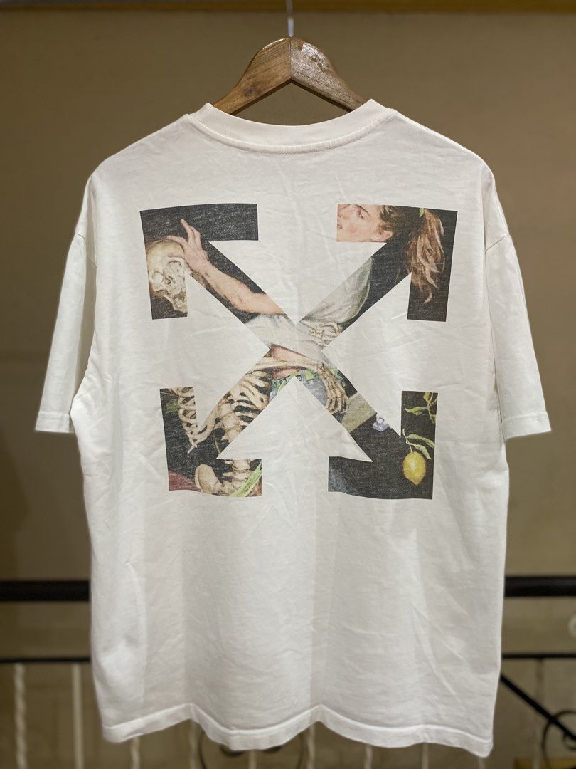 OFF-WHITE " Caravaggio" Tee White (Category: Tshirts & Polo Shirts ) located in Rizal. Submitted by channzy (Listing ID 1460770829, Image 1). Description: - Authentic OFF-WHITE T-Shirt - Tag reads "2013 OFF White" - Iconic Caravaggio graphic print on the back - Small hand graphic on the front - Rare collector's item.