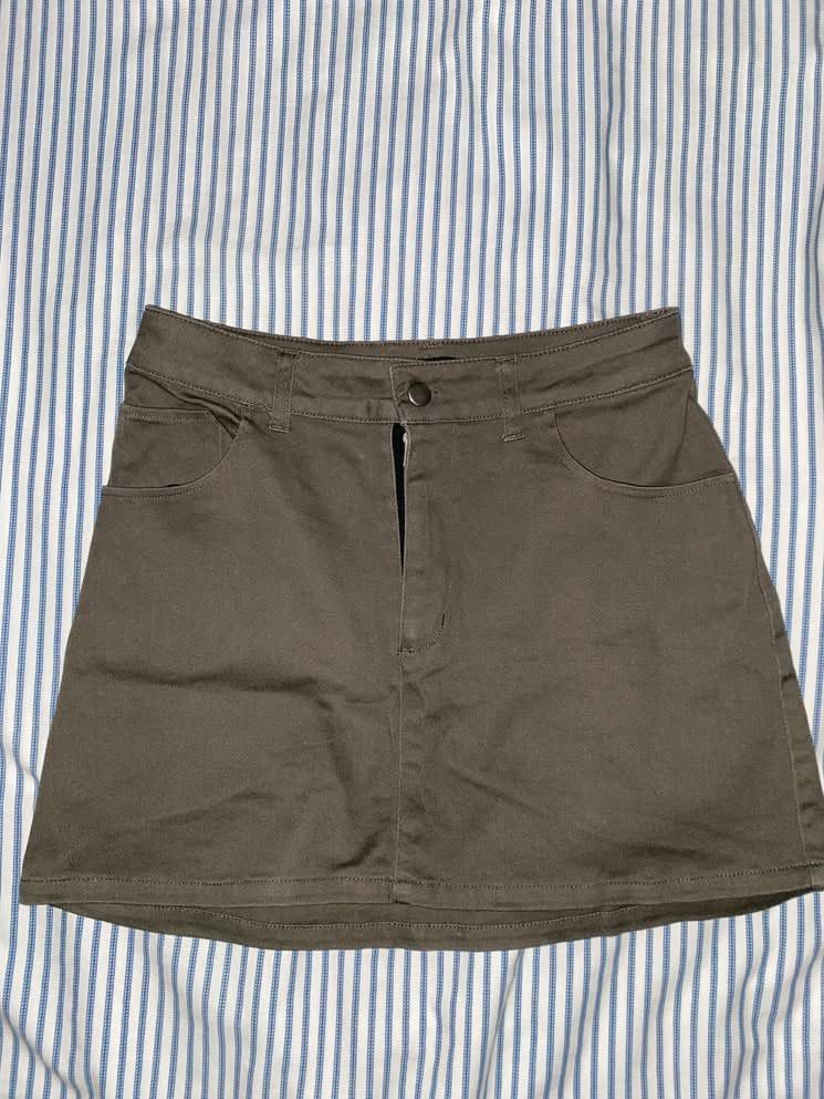 OXGN Olive Green A-Line Mini Skirt (Category: Skirts) located in Manila. Submitted by _dayanughhhh (Listing ID 1460874512, Image 1). Description: - Olive green mini skirt - A-line cut - Front zipper and button closure - Two front pockets - Versatile and great for casual outfits.
